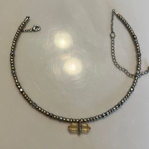 It’s a beautiful crystal choker with beads, an adjustable neckband